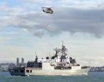 ID 1176 HMNZS TE MANA (F-111), one of the Royal New Zealand Navy's two ANZAC-class frigates, accompanied by her Seasprite helicopter, arrives home in Auckland following an overseas deployment.